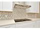 Modern kitchen with a sleek cooktop and stainless steel range hood at 10520 Purple Thistle Way, San Antonio, FL 33576