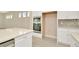 Modern kitchen with built-in oven and microwave, white cabinets and quartz countertops at 10520 Purple Thistle Way, San Antonio, FL 33576