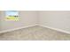 Well-lit bedroom featuring carpeted floors and a large window at 10520 Purple Thistle Way, San Antonio, FL 33576
