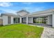Covered patio with gray pavers and a grassy backyard at 10520 Purple Thistle Way, San Antonio, FL 33576