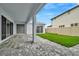 Covered patio with gray pavers and a grassy backyard at 10520 Purple Thistle Way, San Antonio, FL 33576