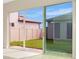 Sliding glass doors open to a grassy backyard with a view of neighboring homes at 10520 Purple Thistle Way, San Antonio, FL 33576