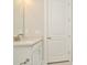 Simple bathroom with white vanity and a door at 10520 Purple Thistle Way, San Antonio, FL 33576