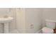 Small powder room with pedestal sink and toilet at 10520 Purple Thistle Way, San Antonio, FL 33576