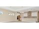 Open concept kitchen boasting white cabinets, an island, and a spacious layout at 10520 Purple Thistle Way, San Antonio, FL 33576