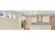 Modern kitchen featuring white cabinets, a stainless steel range hood, and stylish backsplash at 10520 Purple Thistle Way, San Antonio, FL 33576