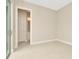 Empty bedroom with light walls and tile floors at 10520 Purple Thistle Way, San Antonio, FL 33576