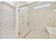 Modern bathroom with a walk-in shower, double sinks, and grey cabinets at 10520 Purple Thistle Way, San Antonio, FL 33576
