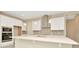 Modern kitchen island with white cabinets and quartz countertops at 10520 Purple Thistle Way, San Antonio, FL 33576