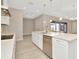 Open kitchen with large island, stainless steel appliances, and view to backyard at 10520 Purple Thistle Way, San Antonio, FL 33576