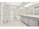 Spa-like bathroom with a soaking tub, double vanity, and glass shower at 10520 Purple Thistle Way, San Antonio, FL 33576