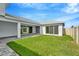 Covered patio with gray pavers and a grassy backyard at 10520 Purple Thistle Way, San Antonio, FL 33576