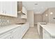 Modern kitchen with white cabinets, quartz countertops and stainless steel appliances at 10520 Purple Thistle Way, San Antonio, FL 33576