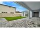 Covered patio with gray pavers and a grassy backyard at 10520 Purple Thistle Way, San Antonio, FL 33576