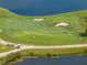 Golf course with players putting on the green near water at 5243 Esplanade Blvd, Bradenton, FL 34211