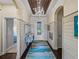Bright entryway with wood-paneled walls, a stylish rug, and a chandelier at 5243 Esplanade Blvd, Bradenton, FL 34211