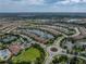 Aerial view of a home in a community with a lake and other homes nearby at 5243 Esplanade Blvd, Bradenton, FL 34211
