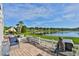 Patio with lake view, seating, and grill at 4790 Snook Se Dr, St Petersburg, FL 33705