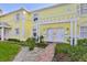 Yellow building exterior with walkway, landscaping, and pergola at 4790 Snook Se Dr, St Petersburg, FL 33705