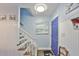 Inviting entryway with staircase and blue door at 4790 Snook Se Dr, St Petersburg, FL 33705