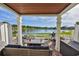 Covered patio overlooking a lake, with seating and grill at 4790 Snook Se Dr, St Petersburg, FL 33705