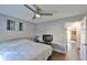 Bedroom with ceiling fan, TV, and access to another room at 4790 Snook Se Dr, St Petersburg, FL 33705
