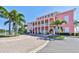 Pink building with palm trees and a brick driveway, offering resort-style living at 4790 Snook Se Dr, St Petersburg, FL 33705