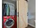 Laundry closet with washer, dryer, and barn door at 4790 Snook Se Dr, St Petersburg, FL 33705