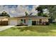 Single story home with a light beige exterior and teal door at 1154 Barbour Ave, Port Charlotte, FL 33948