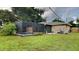 Relaxing pool area with a screened enclosure and lush landscaping at 1154 Barbour Ave, Port Charlotte, FL 33948