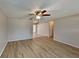 Bright living room featuring light laminate flooring and a ceiling fan at 1154 Barbour Ave, Port Charlotte, FL 33948