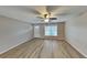 Spacious living room with light walls, laminate floors, and ceiling fan at 1154 Barbour Ave, Port Charlotte, FL 33948