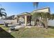 Backyard view showcasing patio, shed, and landscaping at 7720 Rathdown Ln, Wesley Chapel, FL 33545
