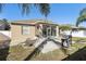 Home's backyard with patio, grill, and fire pit at 7720 Rathdown Ln, Wesley Chapel, FL 33545