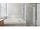 Bathroom with a large garden tub and separate shower at 7720 Rathdown Ln, Wesley Chapel, FL 33545