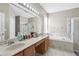 Bathroom with double vanity, garden tub, and separate shower at 7720 Rathdown Ln, Wesley Chapel, FL 33545