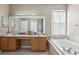 Bathroom with double vanity, garden tub, and separate shower at 7720 Rathdown Ln, Wesley Chapel, FL 33545