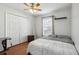 Bright bedroom with double bed, wood floors, and a double door closet at 7720 Rathdown Ln, Wesley Chapel, FL 33545