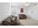 Bonus room with two sofas, ceiling fan, and large window at 7720 Rathdown Ln, Wesley Chapel, FL 33545