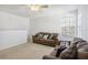 Bonus room with two sofas, ceiling fan and large window at 7720 Rathdown Ln, Wesley Chapel, FL 33545