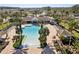 Resort-style pool with lounge chairs and shaded areas at 7720 Rathdown Ln, Wesley Chapel, FL 33545