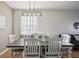 Bright dining area with farmhouse style table and chairs at 7720 Rathdown Ln, Wesley Chapel, FL 33545