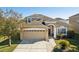 Two-story house with a two-car garage and landscaping at 7720 Rathdown Ln, Wesley Chapel, FL 33545