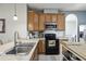 Modern kitchen with stainless steel appliances and breakfast bar at 7720 Rathdown Ln, Wesley Chapel, FL 33545