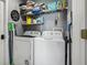 Laundry room with washer, dryer, and shelving for storage at 7720 Rathdown Ln, Wesley Chapel, FL 33545