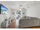 Bright living room with a large sectional sofa and sliding doors to a patio at 7720 Rathdown Ln, Wesley Chapel, FL 33545