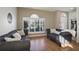 Living room with hardwood floors and two gray sofas at 7720 Rathdown Ln, Wesley Chapel, FL 33545