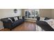 Living room with hardwood floors and two gray sofas at 7720 Rathdown Ln, Wesley Chapel, FL 33545