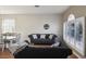 Bright living room featuring comfortable sofas and large windows at 7720 Rathdown Ln, Wesley Chapel, FL 33545