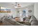 Spacious living room featuring a large sectional sofa and hardwood floors at 7720 Rathdown Ln, Wesley Chapel, FL 33545